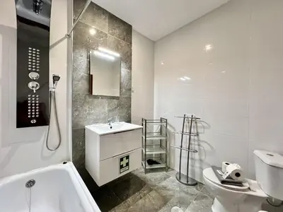 a bathroom with a tub and a toilet and a sink at Albufeira Central 7 by Homing in Albufeira