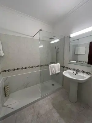 a bathroom with a shower and a sink and a toilet at Apartamento T1 todo equipado in Albufeira