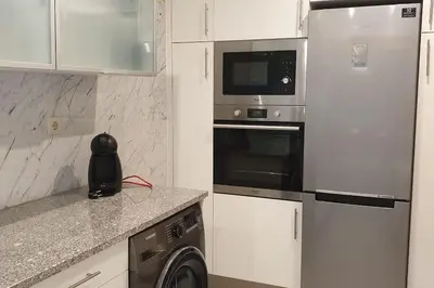 a kitchen with a refrigerator and a microwave at Casa Praia Patroves in Patroves