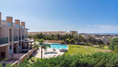 a swimming pool in a yard next to a building at Casa Praia Patroves in Patroves