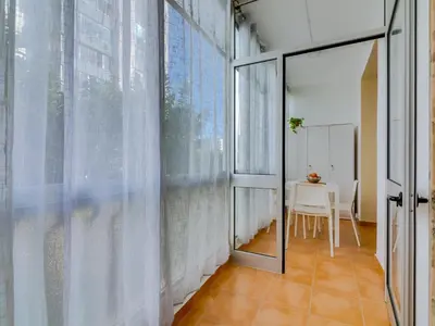 a dining room with a table and a large window at AL - Beachside Hideaway Quarteira in Quarteira