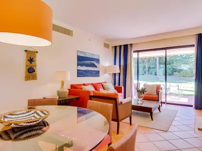 a living room with a couch and a table at AL - Vila Sol Golfside Ground Floor in Vilamoura