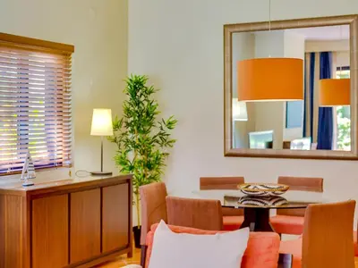 a dining room with a table and a mirror at AL - Vila Sol Golfside Ground Floor in Vilamoura
