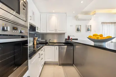 a kitchen with a bowl of oranges on the counter at Phenthouse Monaco - Jacuzzi - City Center - Sea View in Albufeira