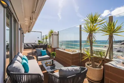 a living room with a view of the ocean at Phenthouse Monaco - Jacuzzi - City Center - Sea View in Albufeira