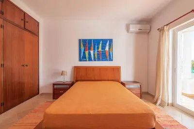 a bedroom with a large bed and a window at Villa Sofy in Galé
