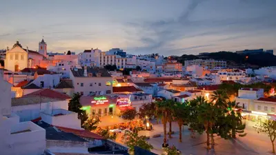 a view of a city at night at 3 min walking to the beach & Old Town by Algarve Dream Holidays in Albufeira