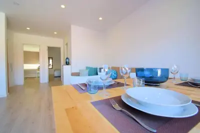 a dining table with a plate and wine glasses on it at 3 min walking to the beach & Old Town by Algarve Dream Holidays in Albufeira