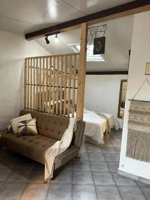 a living room with a couch and a bed at Estúdio em Alte - KARMEA HOUSES in Alte