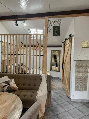 a living room with a couch and a table at Estúdio em Alte - KARMEA HOUSES in Alte
