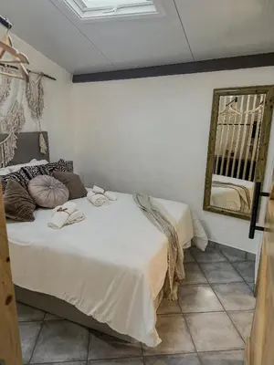 a bedroom with two beds and a mirror on the wall at Estúdio em Alte - KARMEA HOUSES in Alte