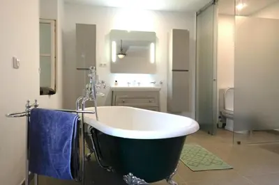 a bathroom with a bath tub and a sink at Quinta Amarela XL by Portucasa in Loulé