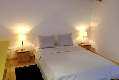 a bedroom with a large bed with two lamps at Quinta Amarela XL by Portucasa in Loulé