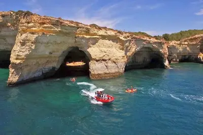 a group of people in a boat in the water near a cave at Solymar Apartment in Guia