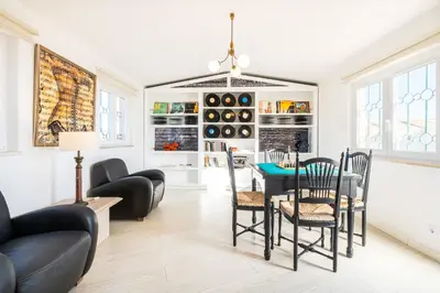 a living room with a table and chairs at Villa Eagles Nest by Algarve Vacation in Albufeira