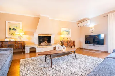 a living room with a table and a fireplace at Villa Eagles Nest by Algarve Vacation in Albufeira