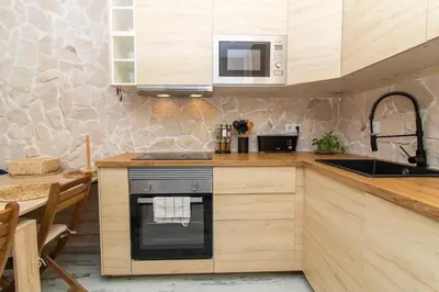 a kitchen with a sink and a stove top oven at Gyula Old Town Apartment in Albufeira