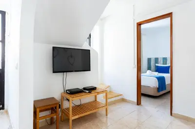 a living room with a television and a bed at #197 Casa Gili by Home Holidays in Albufeira
