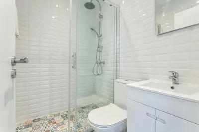 a bathroom with a shower and a toilet and a sink at Blife Farensya private rooms near train station in Faro