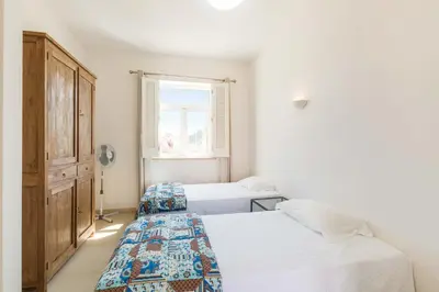 a bedroom with two beds and a window at Villa Ataboeira in Guia