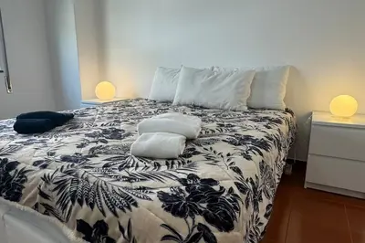 a bedroom with a bed with two pillows on it at XperienceHouse Algarve in Quarteira
