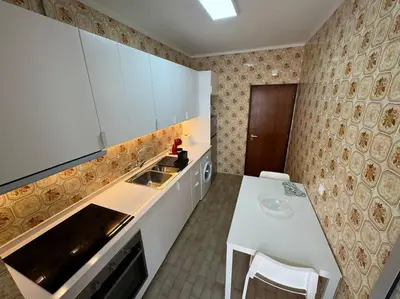 a kitchen with a white counter and a sink at XperienceHouse Algarve in Quarteira