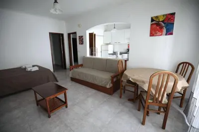 a living room with a couch and a table at STUDIO COMPLETO PARA 2 PESSOAS in Albufeira