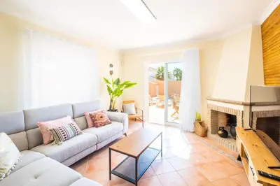 a living room with a couch and a fireplace at Villa alhabu in Albufeira