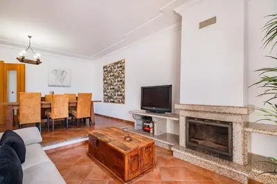 a living room with a couch and a fireplace at Villa Adriana in Albufeira