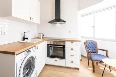 a kitchen with a washing machine and a washer at SERAFIM BEACH APARTMENT - Heart of the Old Town in Albufeira