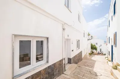 an alley with white buildings and a window at SERAFIM BEACH APARTMENT - Heart of the Old Town in Albufeira