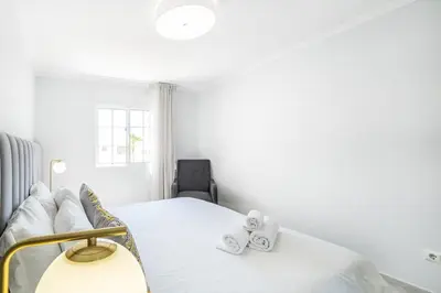 a bedroom with a bed with two towels on it at Apartamento Casa Vela in Albufeira