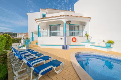 a villa with a swimming pool and a house at Villa Melissa in Albufeira