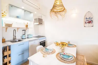 a kitchen with a table with plates on it at Anabella Guest House in Albufeira