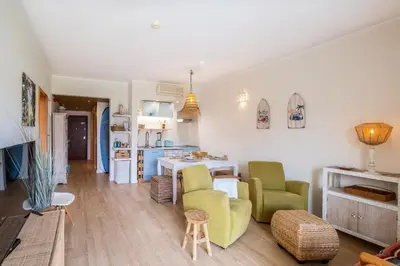 a living room with two chairs and a table at Anabella Guest House in Albufeira