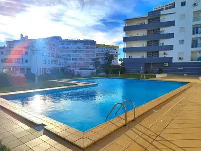 a large swimming pool in front of some buildings at Albufeira Vintage Apartment 1 With Pool by Homing in Albufeira