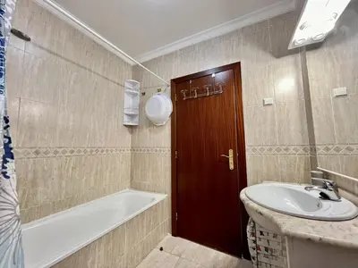 a bathroom with a bath tub and a sink at Albufeira Vintage Apartment 1 With Pool by Homing in Albufeira