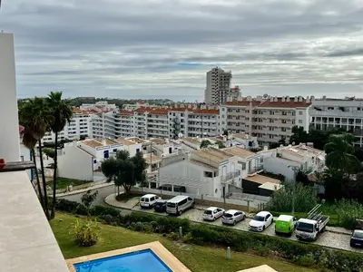 a city with cars parked in a parking lot at Albufeira Vintage Apartment 1 With Pool by Homing in Albufeira