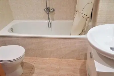 a bathroom with a tub and a toilet and a sink at Charming 3 bed apartment @ Al-Sakia Village in Quarteira