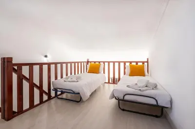 two beds in a room with a balcony at Apartment Arrifes in Albufeira