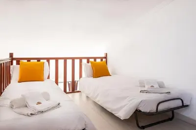 two beds sitting next to each other in a room at Apartment Arrifes in Albufeira