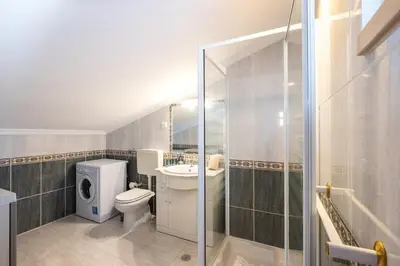 a bathroom with a toilet and a sink and a shower at Apartment Arrifes in Albufeira