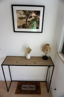 a table with a lamp and a picture on the wall at Three Bedroom Sea View Townhouse Villa in Albufeira