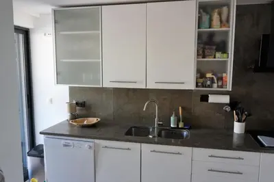 a kitchen with white cabinets and a sink at Three Bedroom Sea View Townhouse Villa in Albufeira