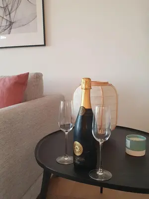 a bottle of champagne and two wine glasses on a table at Three Bedroom Sea View Townhouse Villa in Albufeira