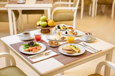 a breakfast table with plates of food on it at Pine Cliffs Suites in Albufeira