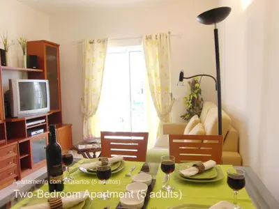 a living room with a table with glasses of wine at Akisol Albufeira Ocean II in Albufeira