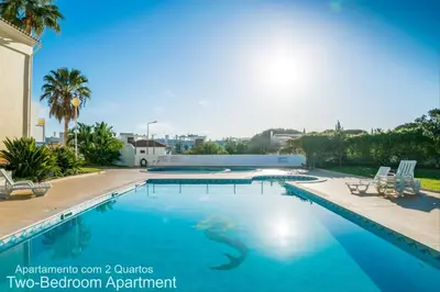 a swimming pool with a snake in the water at Akisol Albufeira Ocean II in Albufeira