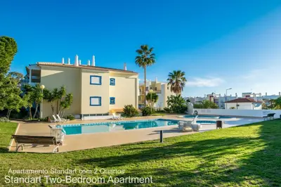 a villa with a swimming pool and a house at Akisol Albufeira Ocean II in Albufeira
