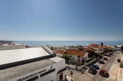 a living room with a table and chairs and a balcony at The Albufeira Concierge - Prime Beach Center L3 in Albufeira